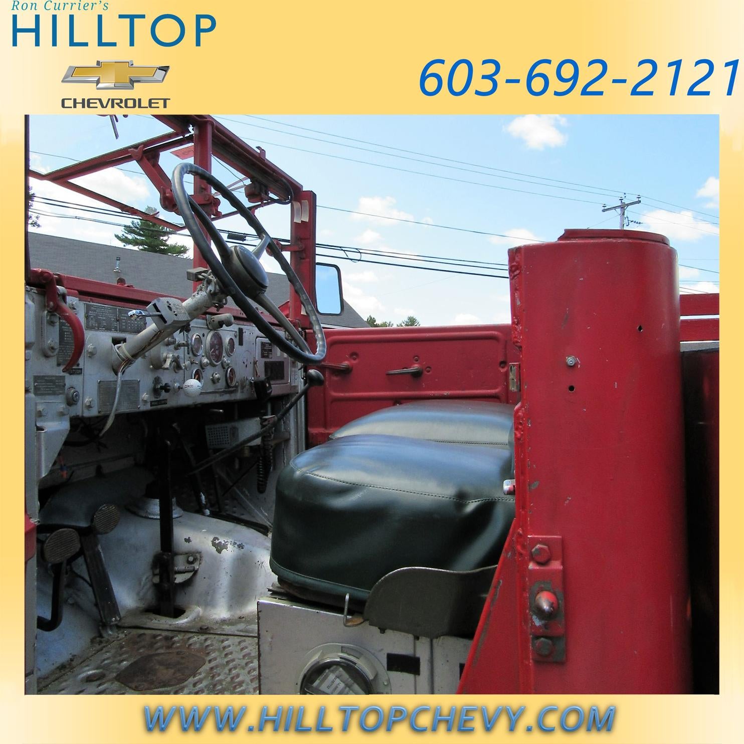 Interior of a vintage vehicle with various controls and gauges.