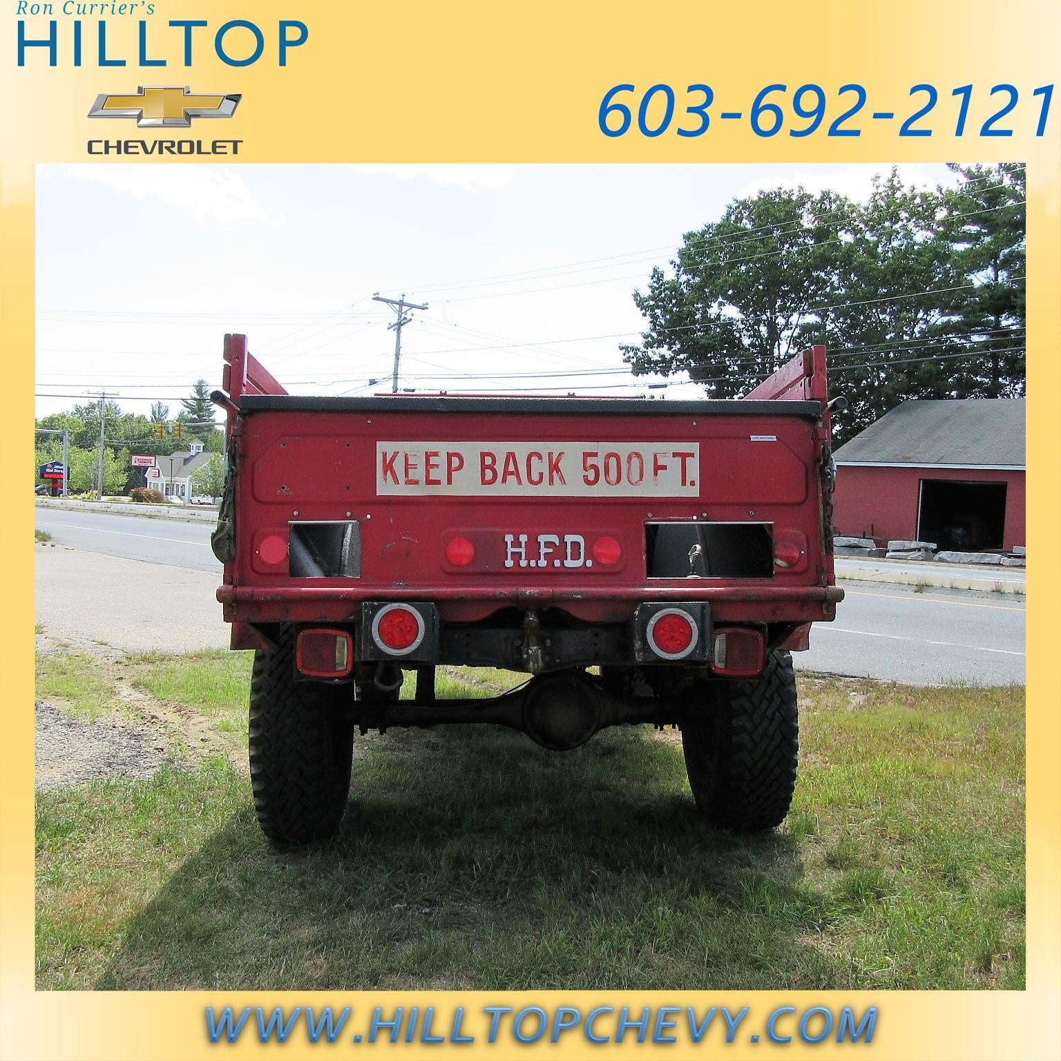 Back of a red truck with KEEP BACK 500 FT. and H.F.D. written on it.