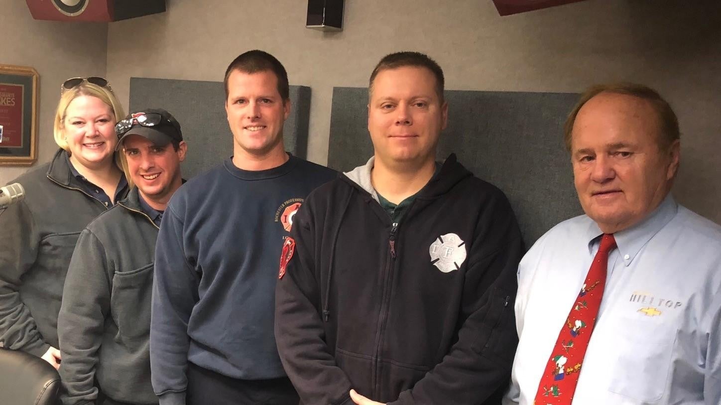 Five people in a room, faces obscured. Mix of casual and professional attire.