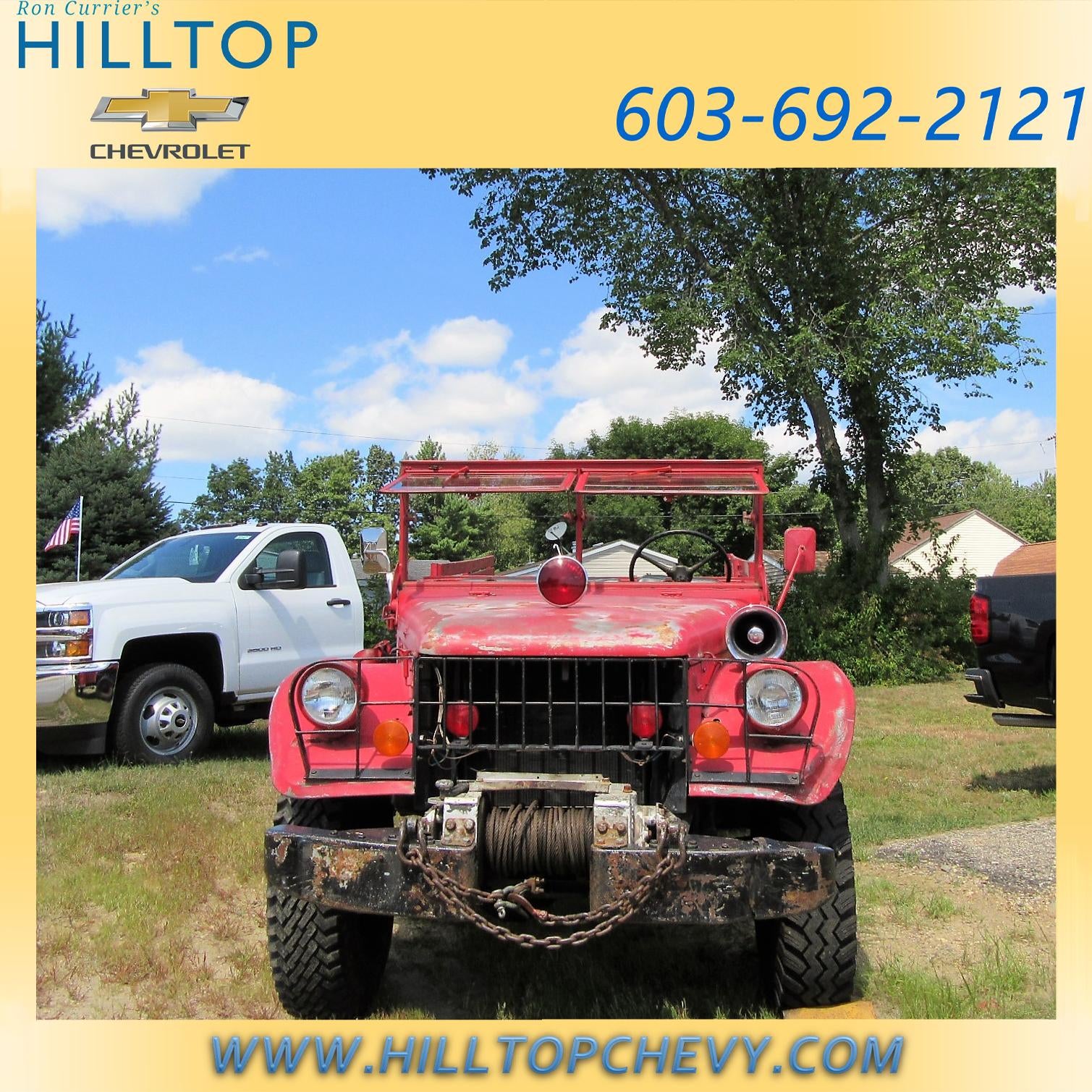 Red vintage off-road vehicle with a winch and chain on the front bumper.