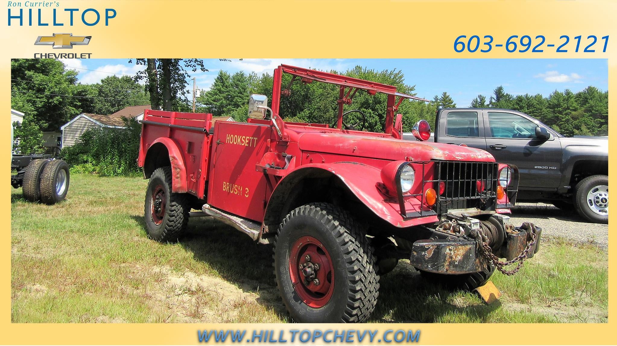 Red vintage military-style truck with 'MOCKETT' and 'M151A2' written on the side.
