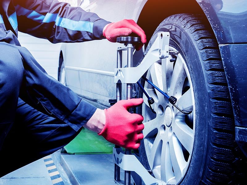Technician repairing a car tire